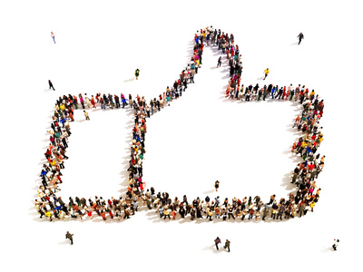 Large group of people in the shape of a thumbs up.